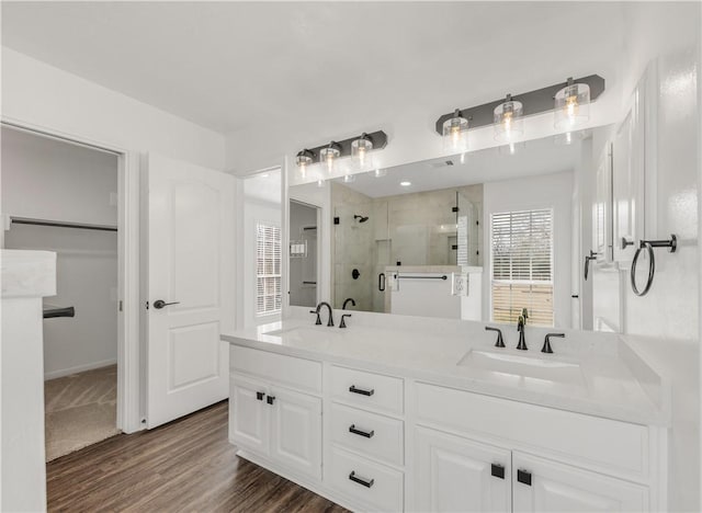 bathroom featuring vanity, an enclosed shower, and hardwood / wood-style floors