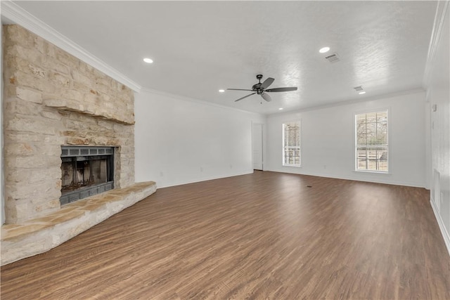 unfurnished living room featuring wood-type flooring, ornamental molding, ceiling fan, and a fireplace