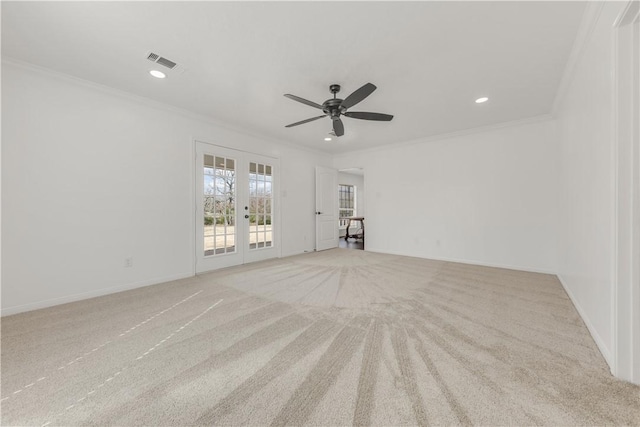 carpeted empty room with ornamental molding, ceiling fan, and french doors