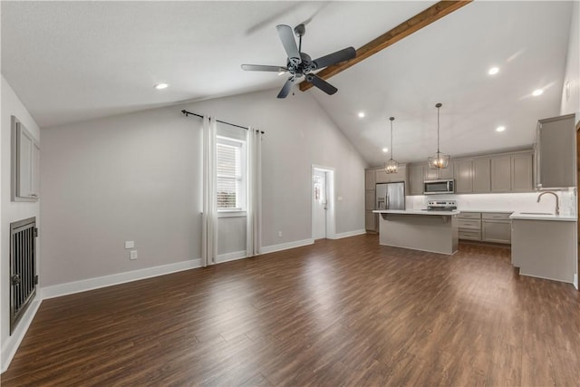 unfurnished living room with ceiling fan, high vaulted ceiling, dark hardwood / wood-style floors, and sink