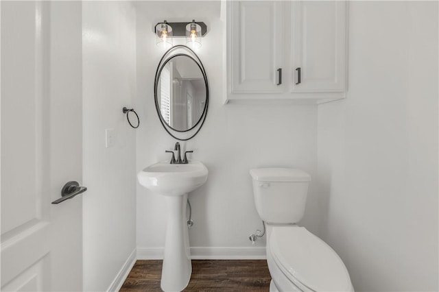 bathroom with hardwood / wood-style floors and toilet