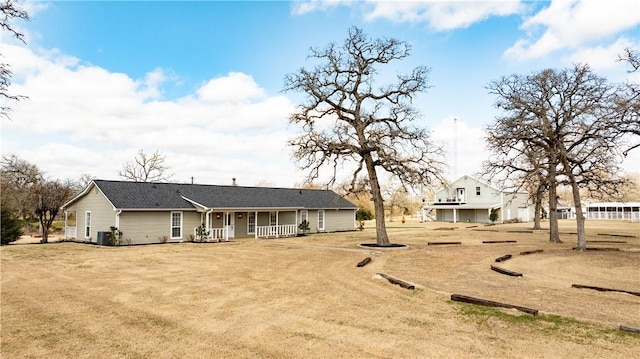 view of front of property with covered porch and a front lawn