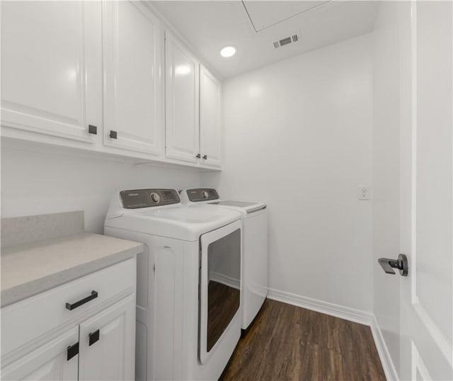 clothes washing area with cabinets, dark wood-type flooring, and independent washer and dryer