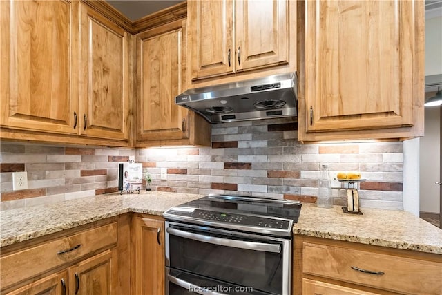 kitchen featuring stainless steel range with electric stovetop, light stone countertops, and tasteful backsplash