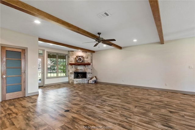 unfurnished living room with beamed ceiling, ceiling fan, a fireplace, and hardwood / wood-style flooring