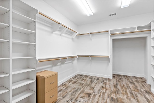 spacious closet featuring hardwood / wood-style flooring