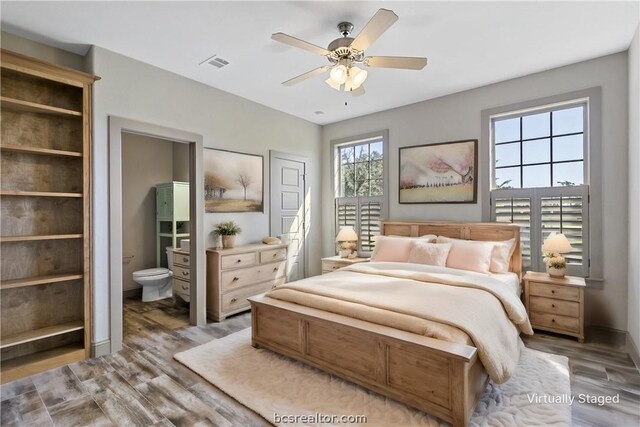 bedroom with connected bathroom, ceiling fan, and wood-type flooring