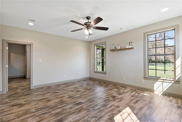 empty room with ceiling fan and hardwood / wood-style flooring