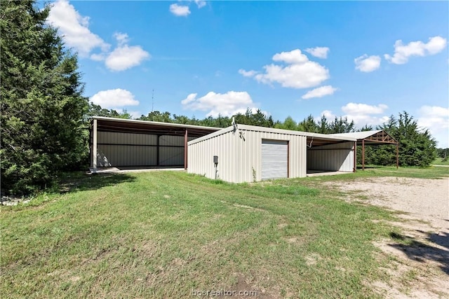 view of outdoor structure with a garage and a lawn