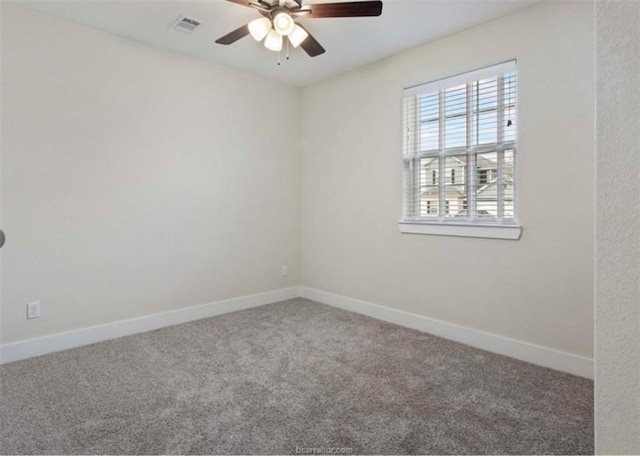 carpeted empty room with baseboards, visible vents, and ceiling fan