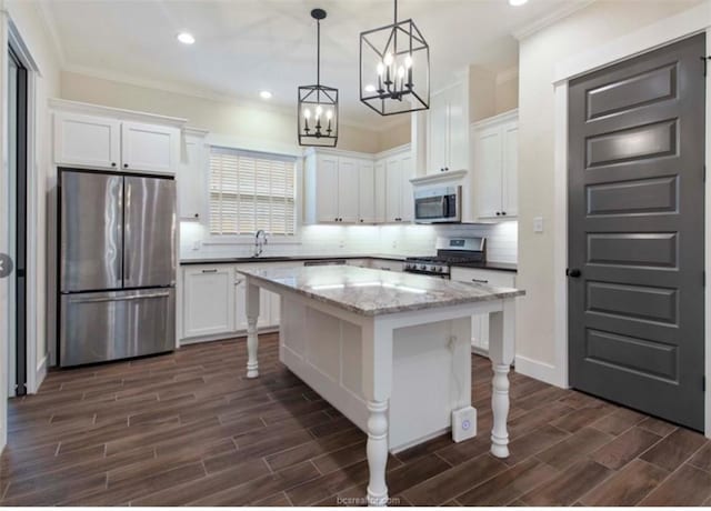 kitchen with white cabinetry, wood tiled floor, stainless steel appliances, and a center island