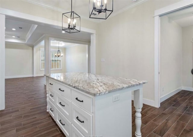 kitchen with white cabinetry, wood finish floors, ornamental molding, and a chandelier