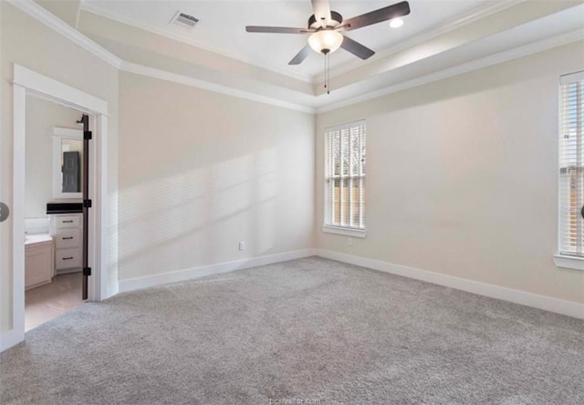 unfurnished room featuring ornamental molding, light colored carpet, and a wealth of natural light