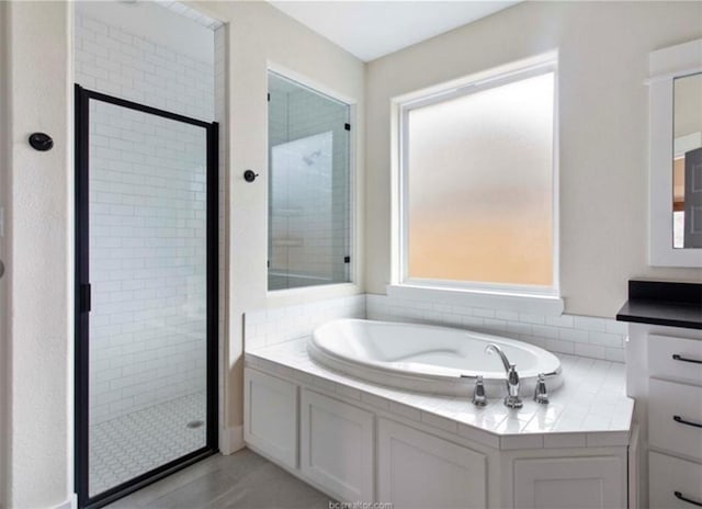 bathroom with a bath and a shower stall