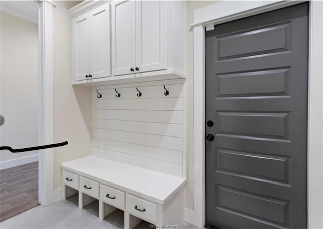 mudroom featuring light wood-style flooring and baseboards
