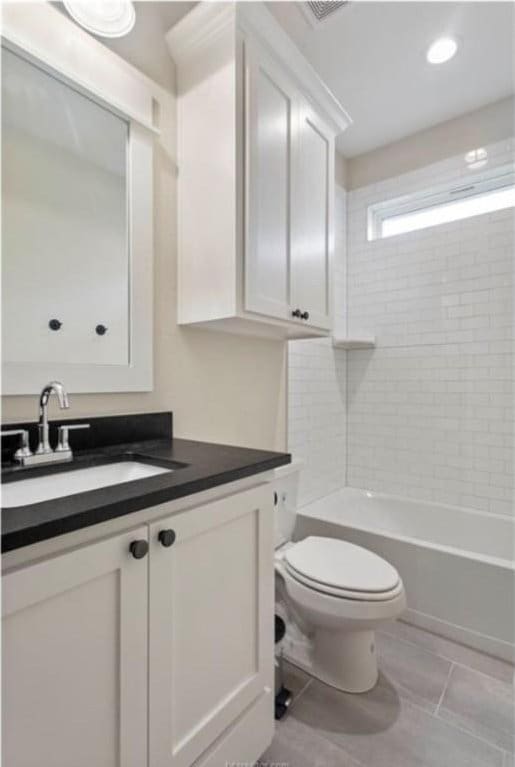 bathroom with toilet, vanity, and shower / bath combination