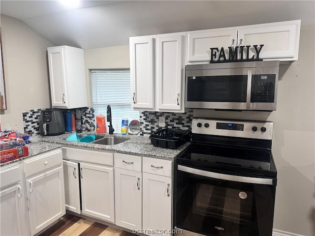 kitchen with backsplash, white cabinetry, light stone counters, and appliances with stainless steel finishes