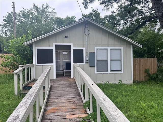 back of property featuring a lawn