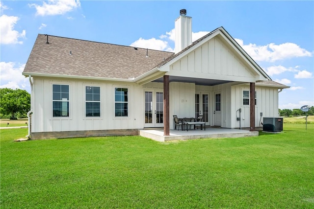 3785 County Road 405, Anderson, TX 77830 - back of house with french doors, board and batten siding, a yard, a shingled roof, and a patio