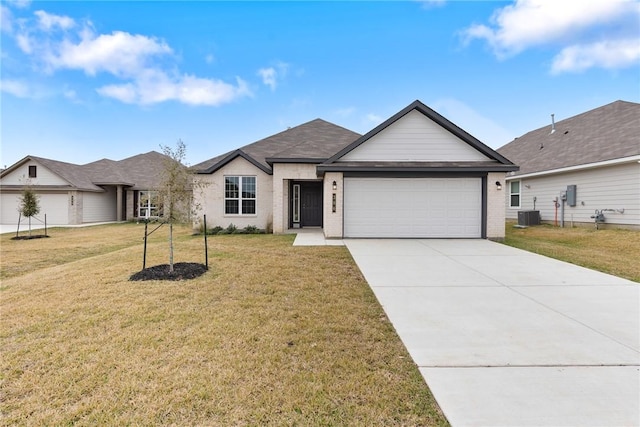 ranch-style home with cooling unit, a front yard, and a garage