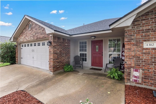 view of front of property with driveway, roof with shingles, brick siding, and a garage