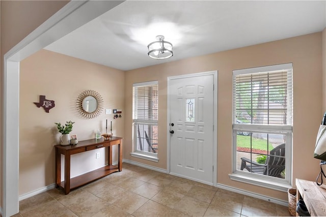 entrance foyer featuring light tile patterned floors and baseboards