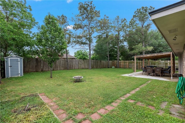 view of yard featuring a fenced backyard, an outdoor structure, a fire pit, a storage unit, and a patio