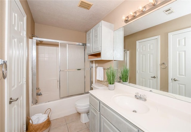bathroom featuring tile patterned floors, visible vents, vanity, and toilet