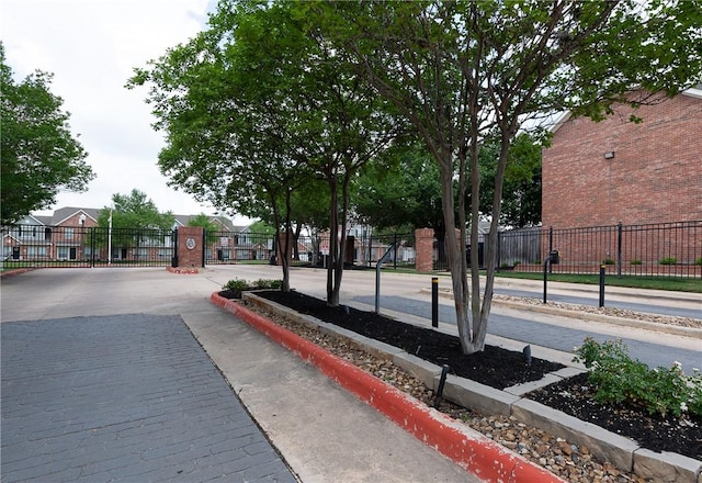 surrounding community with a gate and fence