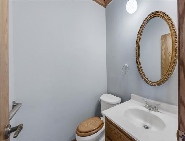 half bath featuring toilet and vanity