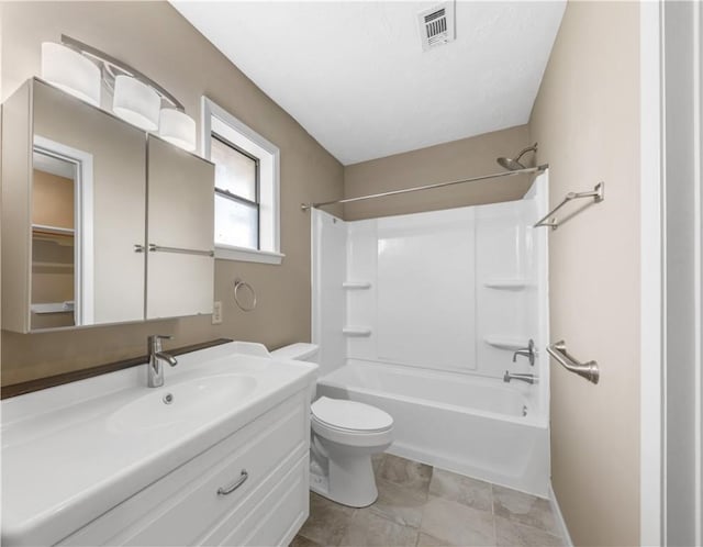 bathroom with visible vents, toilet,  shower combination, and vanity