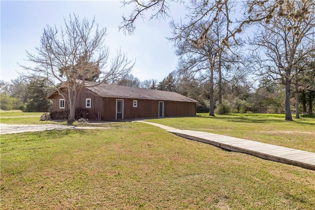 view of side of home featuring a lawn