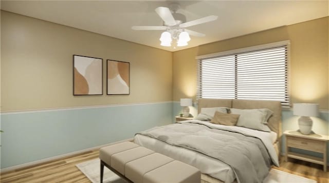 bedroom with a ceiling fan and light wood-style floors