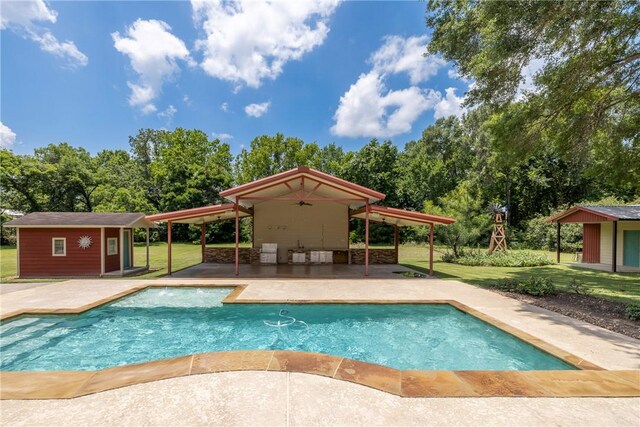 2629 Benton Dr, Brenham, TX 77833 - swimming pool featuring a patio area, an outbuilding, and a lawn