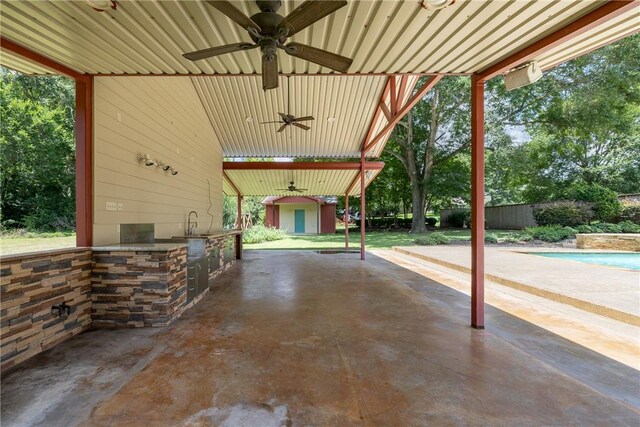 2629 Benton Dr, Brenham, TX 77833 - view of patio / terrace featuring an outdoor kitchen, a ceiling fan, and a storage shed
