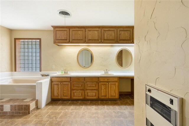 2629 Benton Dr, Brenham, TX 77833 - bathroom featuring heating unit, double vanity, and a garden tub