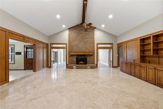 2629 Benton Dr, Brenham, TX 77833 - unfurnished living room with ceiling fan, beamed ceiling, high vaulted ceiling, a brick fireplace, and recessed lighting