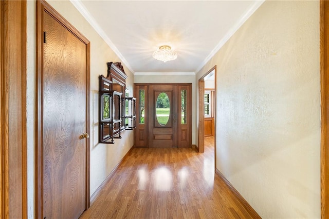 2629 Benton Dr, Brenham, TX 77833 - doorway to outside with light wood-style floors, a chandelier, and ornamental molding