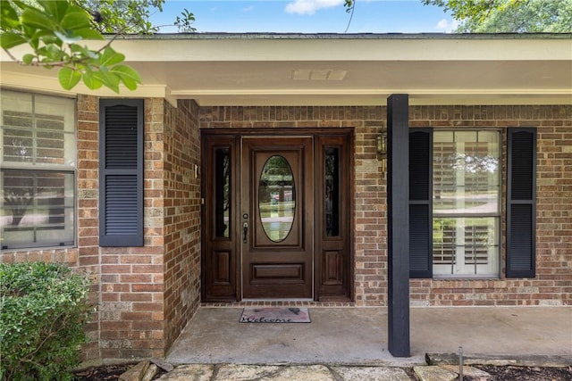2629 Benton Dr, Brenham, TX 77833 - view of exterior entry with brick siding and a porch