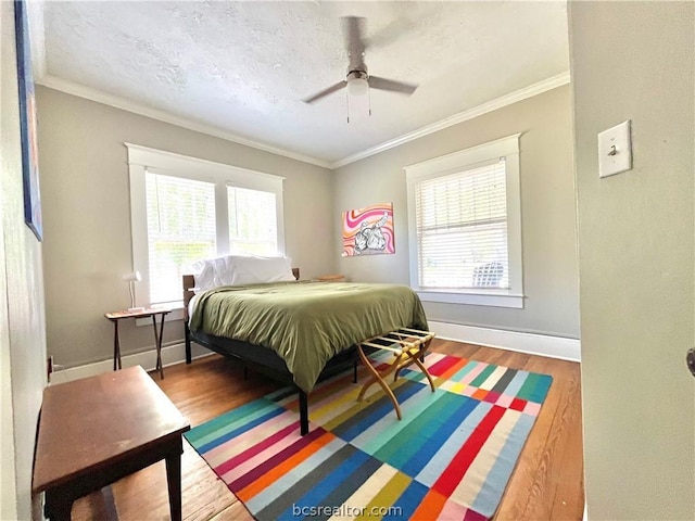 708 E 27th St E, Bryan, TX 77803 - bedroom featuring hardwood / wood-style flooring, ceiling fan, and ornamental molding