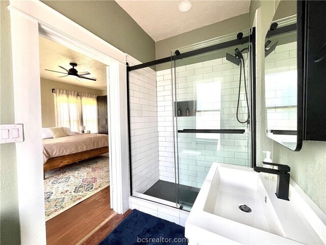 708 E 27th St E, Bryan, TX 77803 - bathroom featuring hardwood / wood-style floors, ceiling fan, sink, and walk in shower