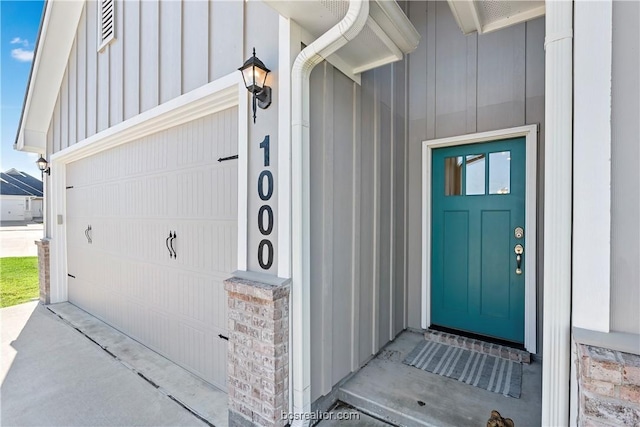 1000 Granite Ct, Bryan, TX 77803 - property entrance with board and batten siding and a garage