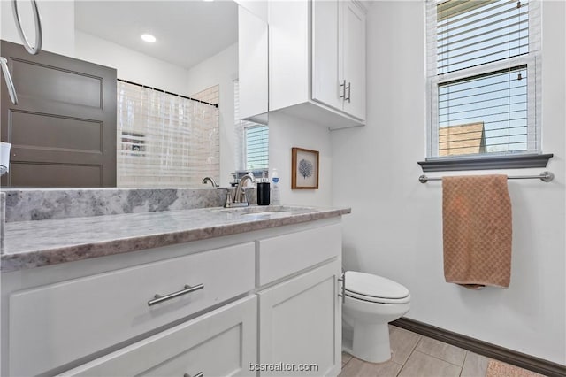 1000 Granite Ct, Bryan, TX 77803 - full bathroom with baseboards, toilet, vanity, and a shower with curtain