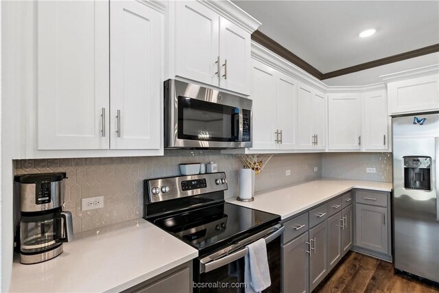 1000 Granite Ct, Bryan, TX 77803 - kitchen with stainless steel appliances, gray cabinetry, light countertops, dark wood-type flooring, and crown molding