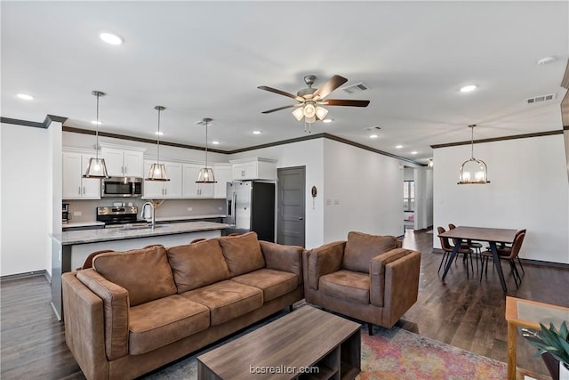 1000 Granite Ct, Bryan, TX 77803 - living area with a ceiling fan, ornamental molding, recessed lighting, dark wood-type flooring, and a chandelier