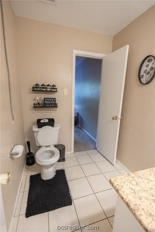 bathroom with tile patterned floors, vanity, and toilet