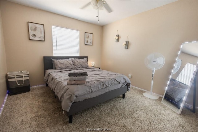 bedroom featuring ceiling fan and carpet