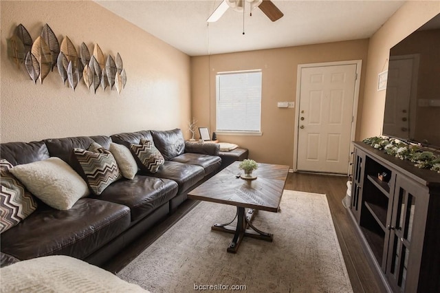 living room featuring dark hardwood / wood-style flooring and ceiling fan