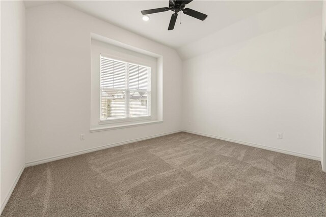 unfurnished room featuring lofted ceiling, carpet floors, and ceiling fan