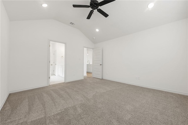 unfurnished bedroom featuring ceiling fan, light colored carpet, and vaulted ceiling